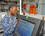 (POLARIS POINT, Guam) May 23, 2017 -- Ens. Brittany Saulsberry, disbursing officer aboard submarine tender USS Emory S. Land (AS 39), opens the front panel of one of the ship’s Navy Cash devices. Saulsberry was recently selected to serve as a supply officer aboard submarines as part of the Women in Submarine Service program. Land and sister ship USS Frank Cable (AS 40) provide maintenance, hotel services, and logistical support to submarines and surface ships in the U.S. 5th and 7th Fleet areas of operation. (U.S. Navy photo by Mass Communication Specialist 2nd Class Richard A. Miller/RELEASED)