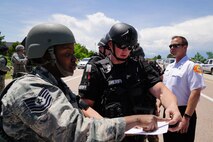 Tech. Sgt. Crisalyn Allen, 50th Security Forces Squadron NCO in charge of operations, and J. Juhl, El Paso County Sheriff’s Office Special Weapons and Tactics deputy, discuss emergency response actions during Opinicus Vista 17-2 at Schriever Air Force Base, Colorado, Wednesday, June 7, 2017. The exercise ran May 30-June 8 and is Schriever’s largest exercise of the year; it tested the wing’s ability to respond to a natural disaster and an active shooter with a hostage. Base and local community first responders worked hand-in-hand to respond to exercise threats. (U.S. Air Force photo/Dennis Rogers)