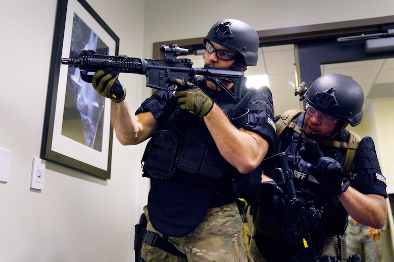 C. Donatell and M. Miller, both El Paso County Sheriff’s Office Special Weapons and Tactics deputies, clear a building during an active shooter exercise at Schriever Air Force Base, Colorado, Wednesday, June 7, 2017. Opinicus Vista 17-2, which ran May 30-June 8, is Schriever’s largest exercise of the year and coordinated efforts between Schriever Air Force Base and local area first responders to engage a wildfire and active shooter with a hostage scenario. (U.S. Air Force photo/Dennis Rogers)