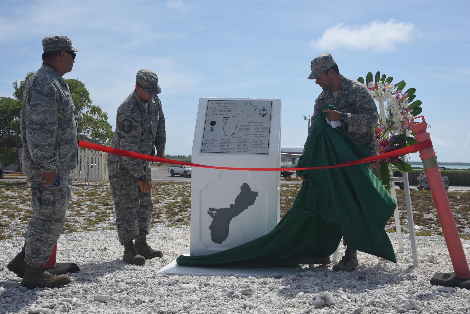 Col. Frank Flores (left), Pacific Air Forces Regional Support Center commander, and Capt. Allen Jaime (right), Wake Island Det. 1 commander, PRSC, unveil the newly renovated memorial during the Guam Memorial rededication ceremony June 8, 2017. The Guam Memorial on Wake Island was erected in 1991 to honor 45 Chamorros from Guam who worked for Pan American airlines. On Dec. 8, 1941, just a few hours of the attack on Pearl Harbor, Hawaii, Japanese forces attacked Wake Island and 10 of the 45 Chamorros were killed in the attack. The remaining 35 men were sent to prison camps in Japan and China where two died in captivity. Due to decades of corrosion, heat and sun, the memorial was degraded to the point where it became unreadable. During many months in 2017, the Guam Memorial was renovated to its original glory.