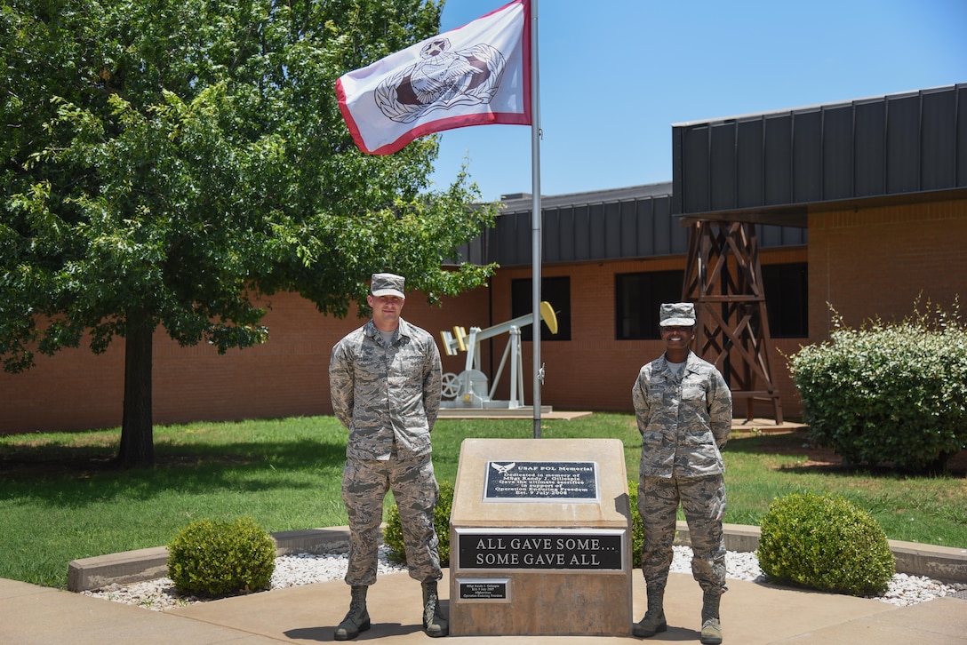 Airman Zachary LeBoeuf and Airman Ashley Watts stand proudly at the Master Sgt. Randy J. Gillespie Petroleum, Oils and Lubricants Memorial, June 13, 2017. POL Airmen in Training begin every morning outside the schoolhouse at this memorial to honor those who made the ultimate sacrifice in service to our country. (U.S. Air Force photo by Master Sgt. Joseph Speirs)