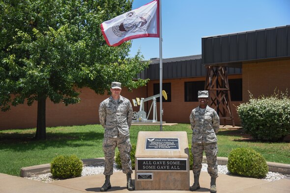 Airman Zachary LeBoeuf and Airman Ashley Watts stand proudly at the Master Sgt. Randy J. Gillespie Petroleum, Oils and Lubricants Memorial, June 13, 2017. POL Airmen in Training begin every morning outside the schoolhouse at this memorial to honor those who made the ultimate sacrifice in service to our country. (U.S. Air Force photo by Master Sgt. Joseph Speirs)