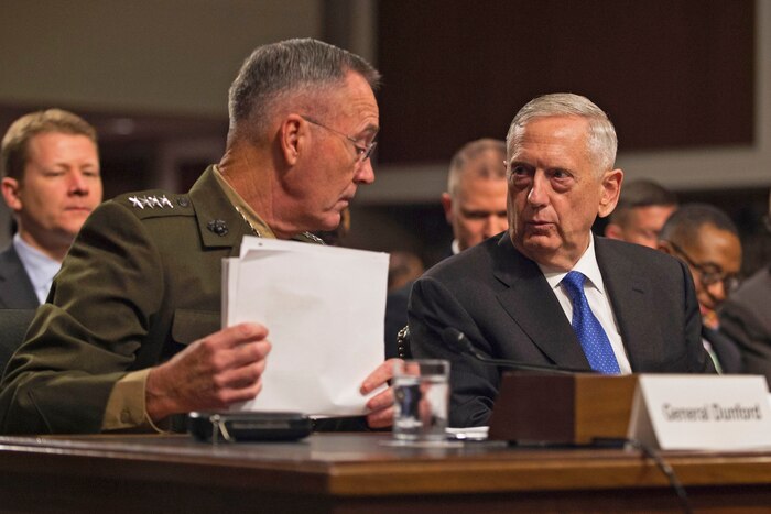 Defense Secretary James N. Mattis and the chairman of the Joint Chiefs of Staff talk during a budget hearing.