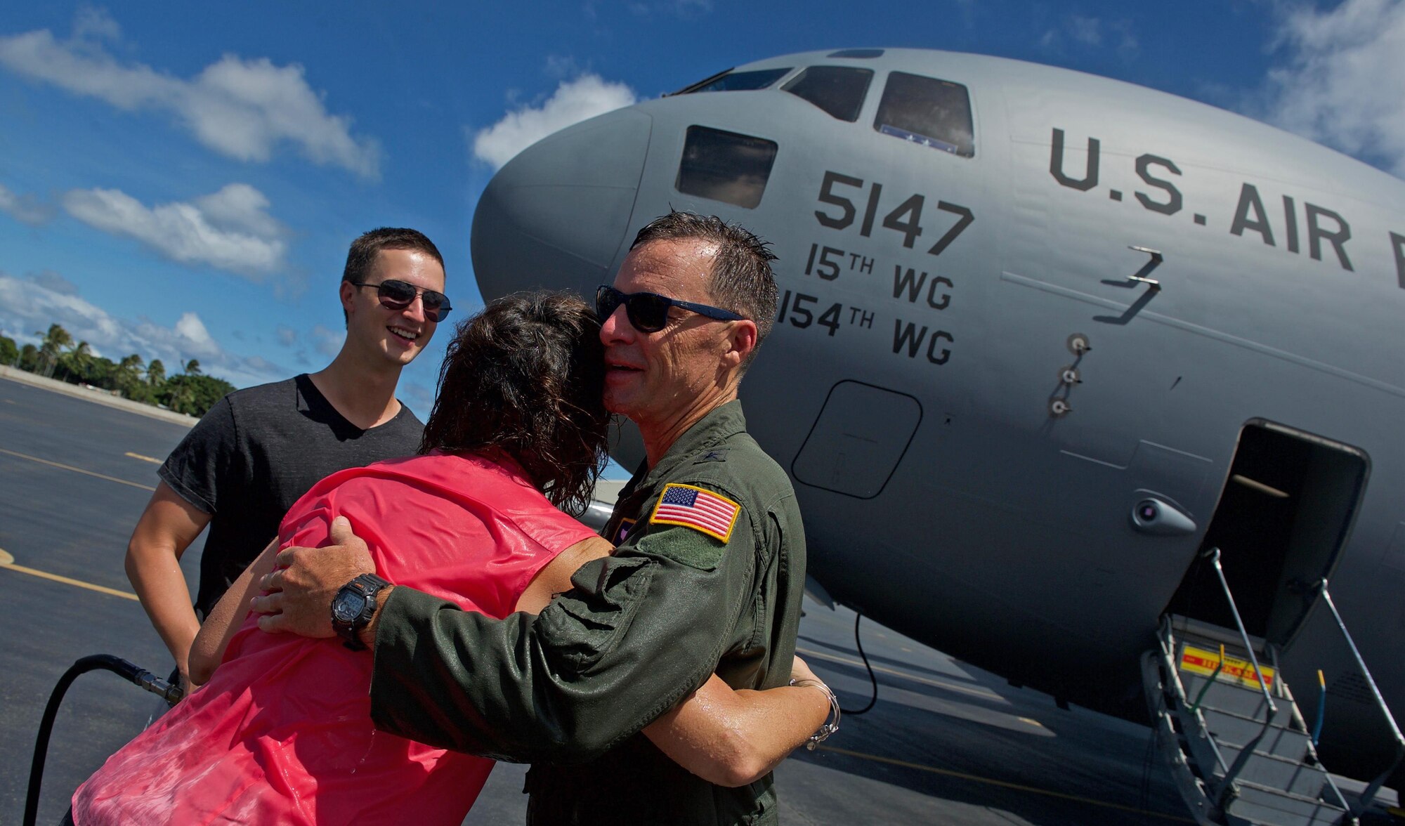 U.S. Air Force Maj. Gen. Mark Dillon, Pacific Air Forces vice commander, is greeted by family and friends and soaked in water and champagne moments after his C-17 fini-flight at Joint Base Pearl Harbor-Hickam, Hawaii, June 12, 2017. With Dillon's retirement approaching, the fini-flight is the capstone event of his flying career. (U.S. Air Force photo/Tech. Sgt. Kamaile Chan)