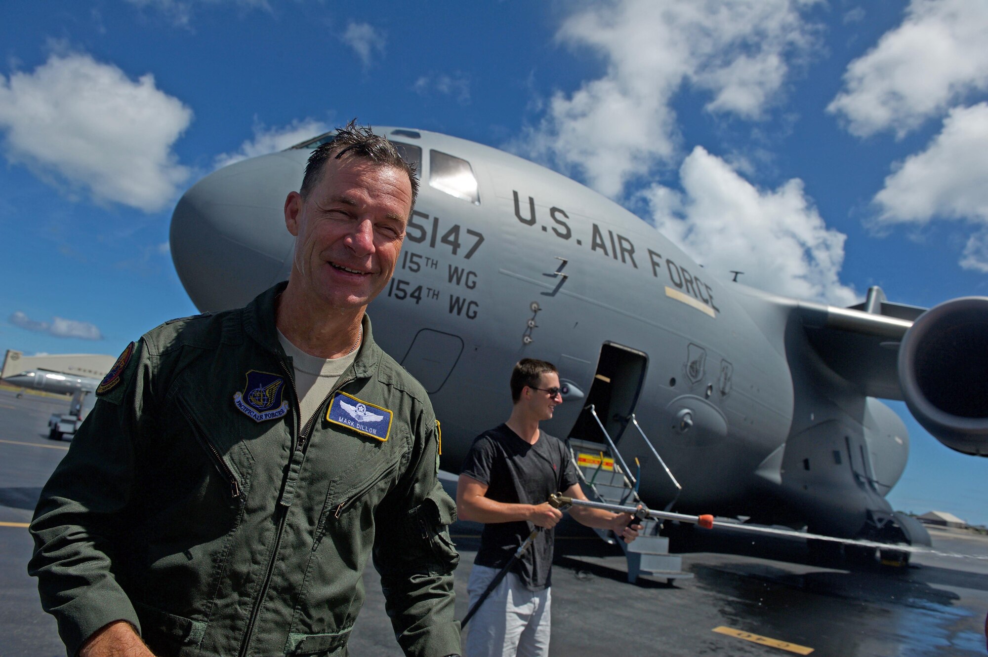 U.S. Air Force Maj. Gen. Mark Dillon, Pacific Air Forces vice commander, is greeted by family and friends and soaked in water and champagne after his C-17 fini-flight at Joint Base Pearl Harbor-Hickam, Hawaii, June 12, 2017. With Dillon's retirement approaching, the fini-flight is the capstone event of his flying career. (U.S. Air Force photo/Tech. Sgt. Kamaile Chan)