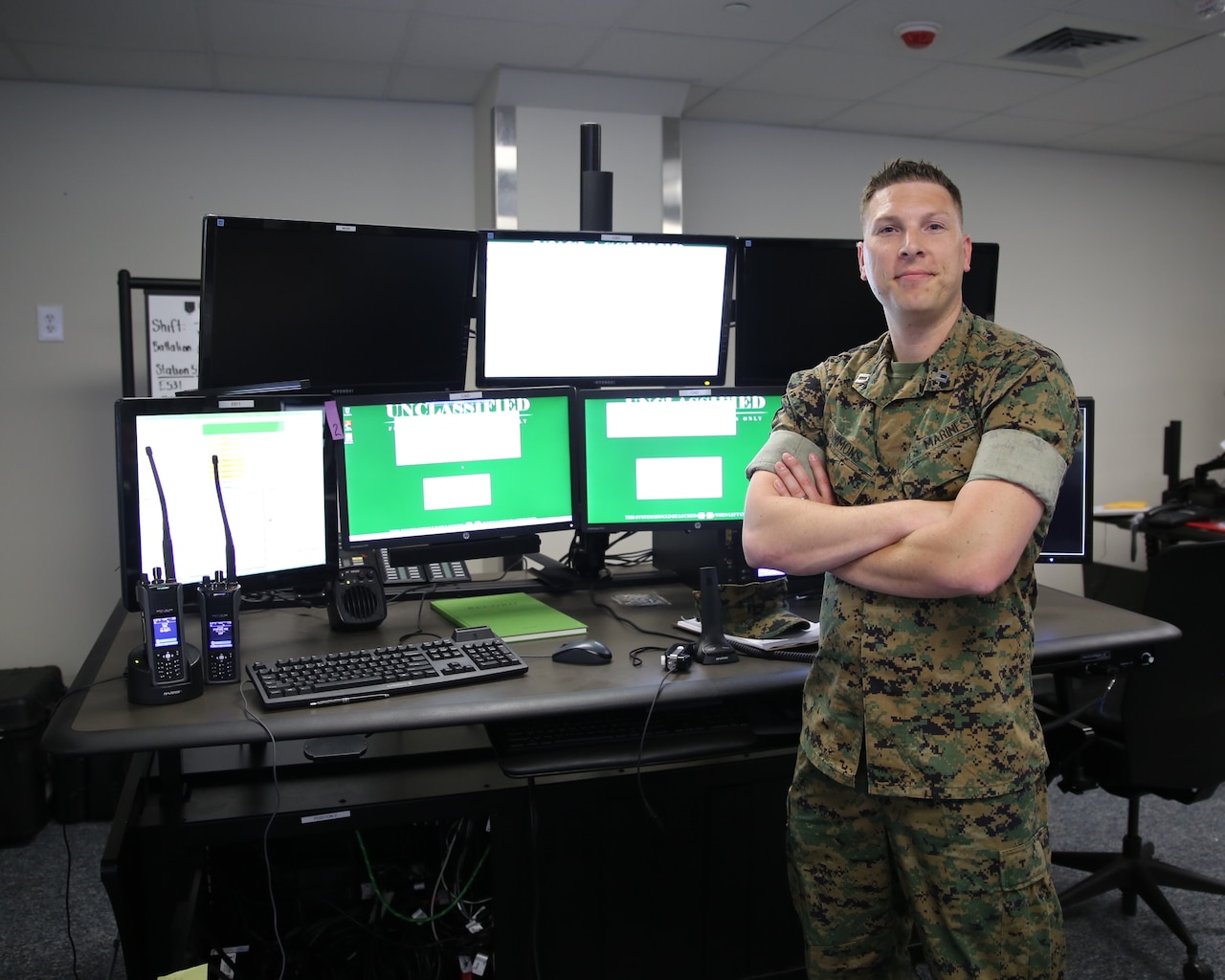 Maj. Mark Simmons, systems engineer for Consolidated Emergency Response System, stands in front of a newly-installed CERS emergency dispatcher workstation aboard Marine Corps Base Quantico, Va.  CERS aggregates multiple capabilities—Enhanced 911, Computer-Aided Dispatch, and fire station alerting—into a single workstation, giving emergency dispatchers the ability to quickly dispatch the appropriate assets where necessary. CERS increases the effectiveness of emergency response operations aboard Marine Corps installations worldwide. (U.S. Marine Corps photo by Ashley Calingo)