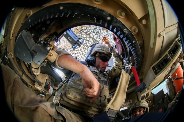 U.S. Army Cpl. Dean Craig, deployed in support of Combined Joint Task Force - Operation Inherent Resolve and assigned to 2nd Brigade Combat Team, 82nd Airborne Division, chats with the truck crew before a movement to an advise and assist patrol base in a neighborhood liberated from ISIS in Mosul, Iraq, June 8, 2017. The 2nd BCT, 82nd Abn. Div. enables their ISF partners through the advise and assist mission, contributing planning, intelligence collection and analysis, force protection, and precision fires to achieve the military defeat of ISIS. CJTF-OIR is the global Coalition to defeat ISIS in Iraq and Syria. (U.S. Army photo by Staff Sgt. Jason Hull)