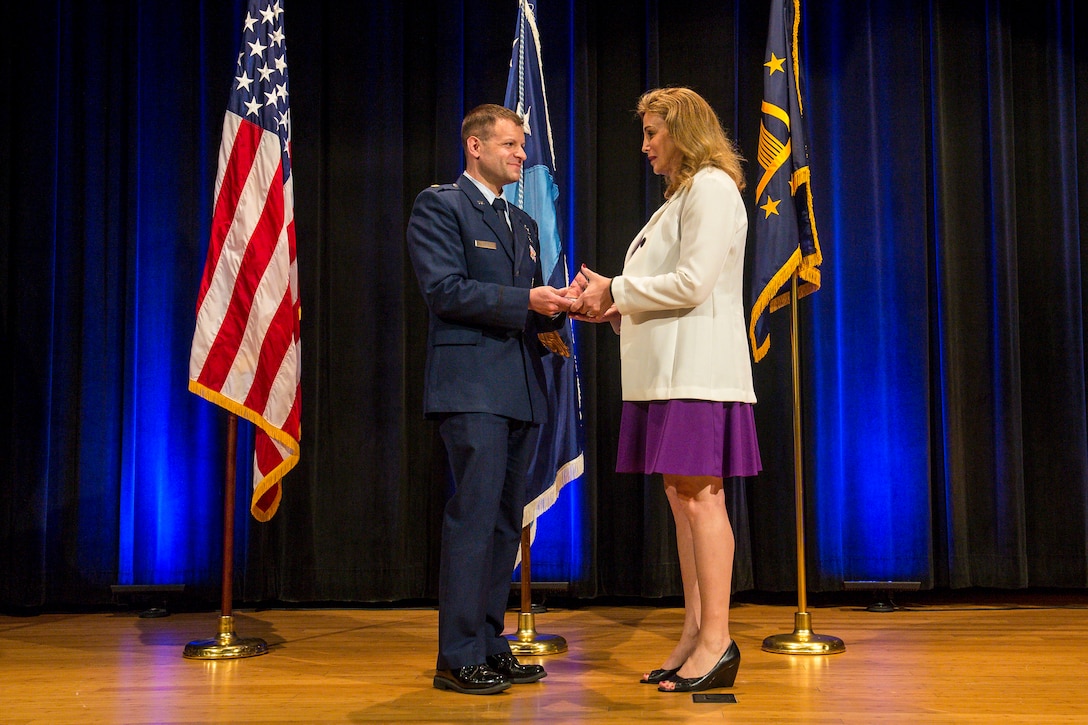 Air Force Maj. Bryan Fram presents a Department of Defense Pride Civilian Leadership Award to Amanda Simpson, former deputy assistant secretary of defense for operational energy, during an award ceremony marking LGBT Pride Month at the Pentagon, June 12, 2017. Army photo by Zane Ecklund