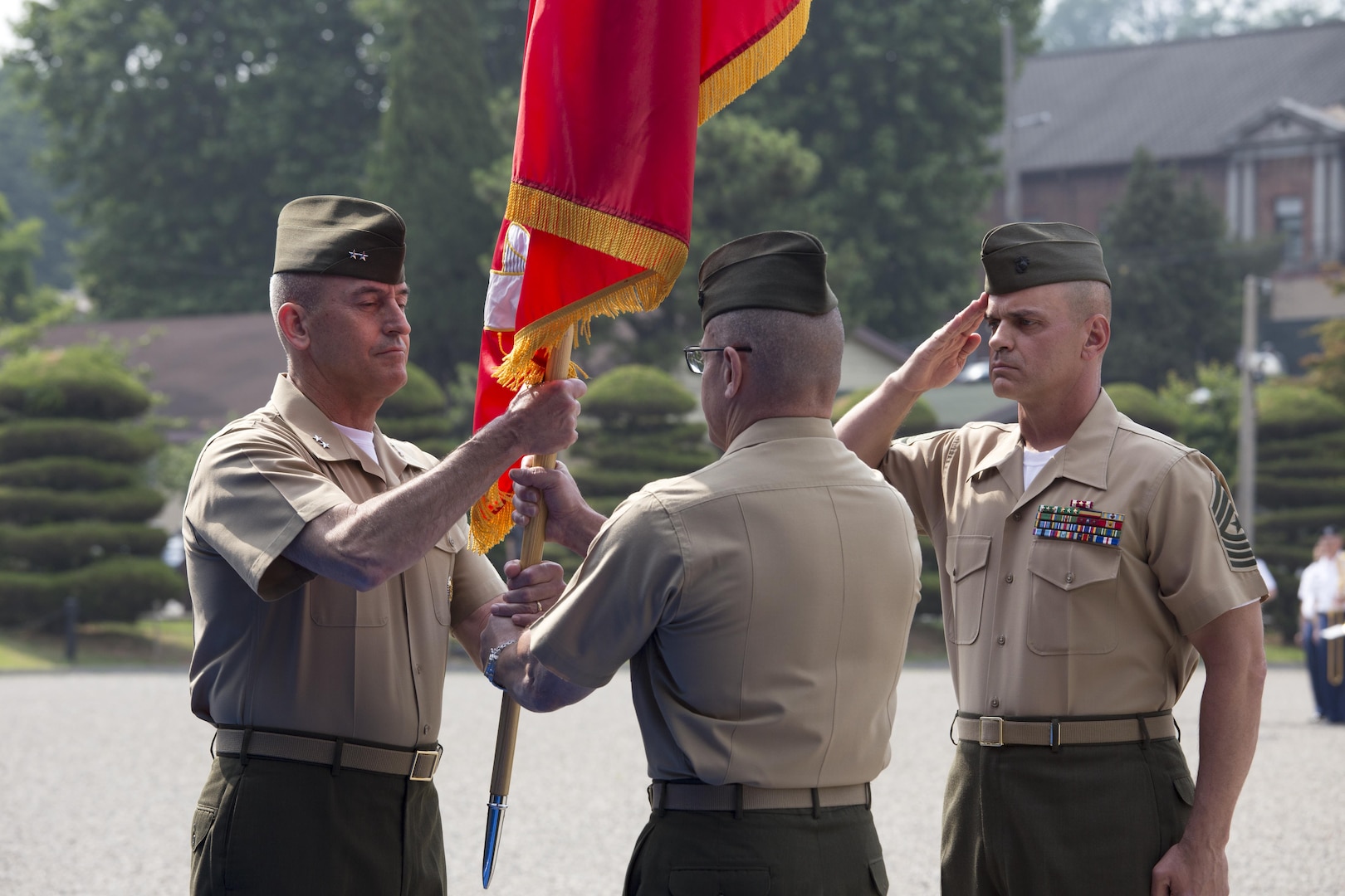 Outgoing U.S. Marine Corps Forces Korea commanding general, Maj. Gen. Robert F. Hedelund (center), passes the colors to his replacement, Maj. Gen. James W. Lukeman in a ceremony at Knight Field, Yongsan, South Korea, June 14. Maj. Gen. Hedelund took command in June of 2015, and his next assignment is commanding general of the 2nd Marine Expeditionary Force.