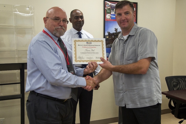 CAMP FOSTER, OKINAWA, Japan – Master Sgt. Terrence C. York graduates from Command Specialist Financial training course June 9 aboard Camp Foster, Okinawa, Japan. The CFS Training is a 40 hour course designed to educate the rates E-6 and above in basic personal financial management. York will act as the liaison between junior Marines and personal financial management specialists, providing basic financial aid, advice and budget proposals. York is the Master Sergeant at 7th Communications Battalion, 3rd Marine Headquarters Group, III Marine Expeditionary Force. (U.S Marine photo by Lance Corporal Tayler P. Schwamb)