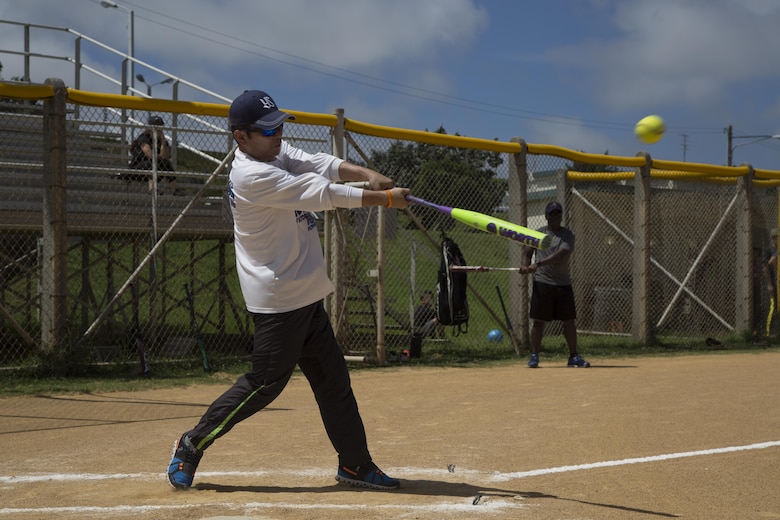 The Mayor of Urasoe City Tetsuji Matsumoto hits the ball during a friendship softball game June 11 aboard Camp Kinser, Okinawa, Japan. Leaders of the military and local community came together for a day of bonding and friendship. Jokes and laughter were heard across the field as the game went on, encouraging comments like “Hit a line drive!” and then as the batter hit the ball foul, behind them, their teammates shouted “No, the other way!”