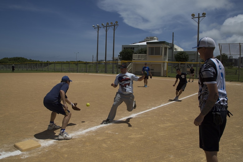 Marine Sgt. Giles Decker runs back and forth while stuck in a ‘pickle’ during a friendship softball game June 11 aboard Camp Kinser, Okinawa, Japan. The teams were integrated, which helped bridge the culture gap, building camaraderie between the local and military communities. Leaders of the military and local community participated in this event: the mayor of Urasoe City, members of the Japan Ground Self-Defense Force, members of city hall, members of the Urasoe City Police Department, the U.S. consul, the sergeant major of Camp Kinser and Feyedelem, the Camp Kinser camp commander, and Marines from Camp Kinser.