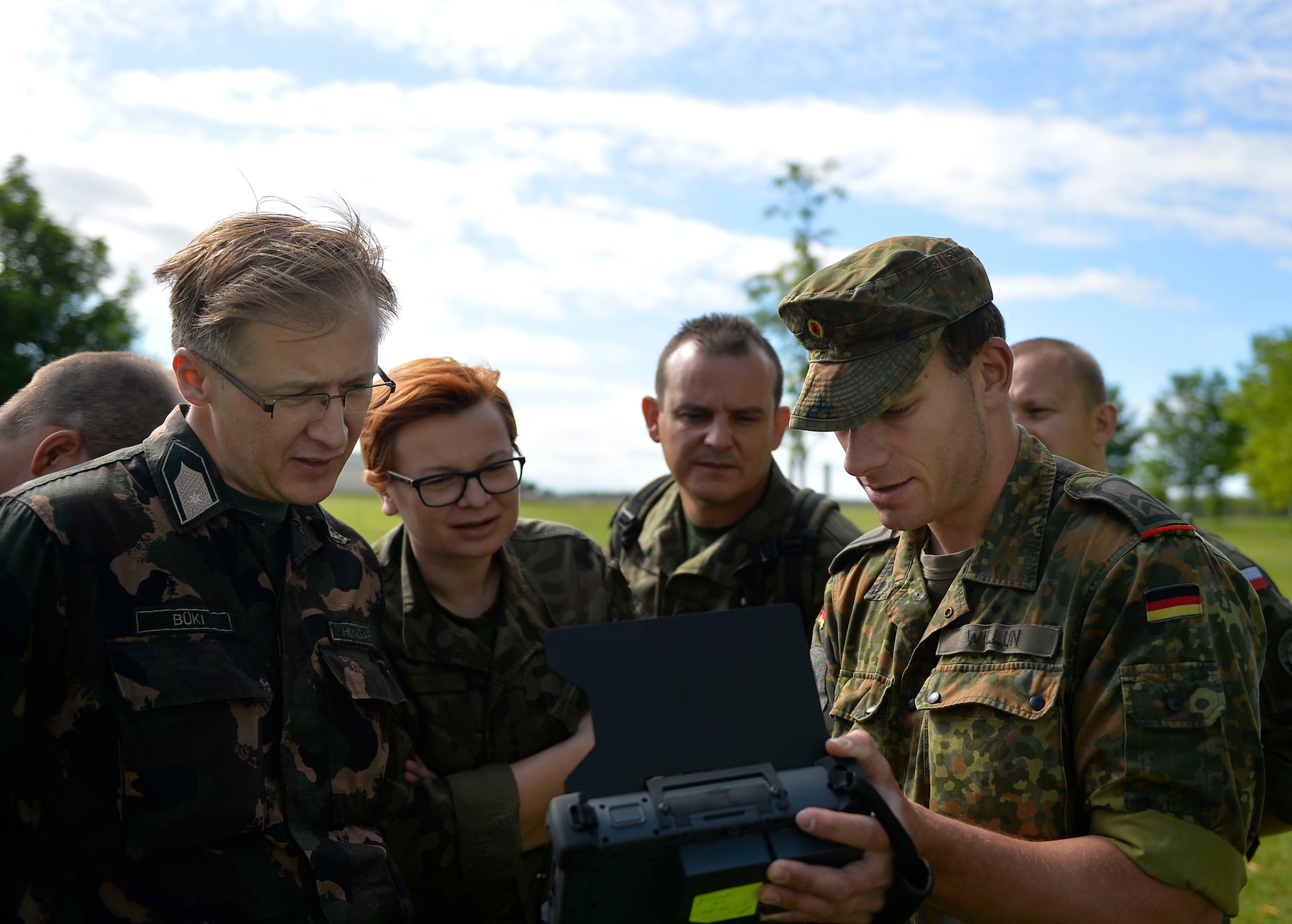 U.S. Air Force Tech. Sgt. Christopher Hardy, 7th Weather Squadron noncommissioned officer  in charge of regional weather maintenance, right, speaks with German NATO partners during a weather-related exercise in Wiesbaden, Germany, June 12, 2017. The 7th WS uses Exercise Cadre Focus to enhance its capability to provide weather support to U.S. Army operations in Europe. (Air Force photo by Airman 1st Class Joshua Magbanua) 