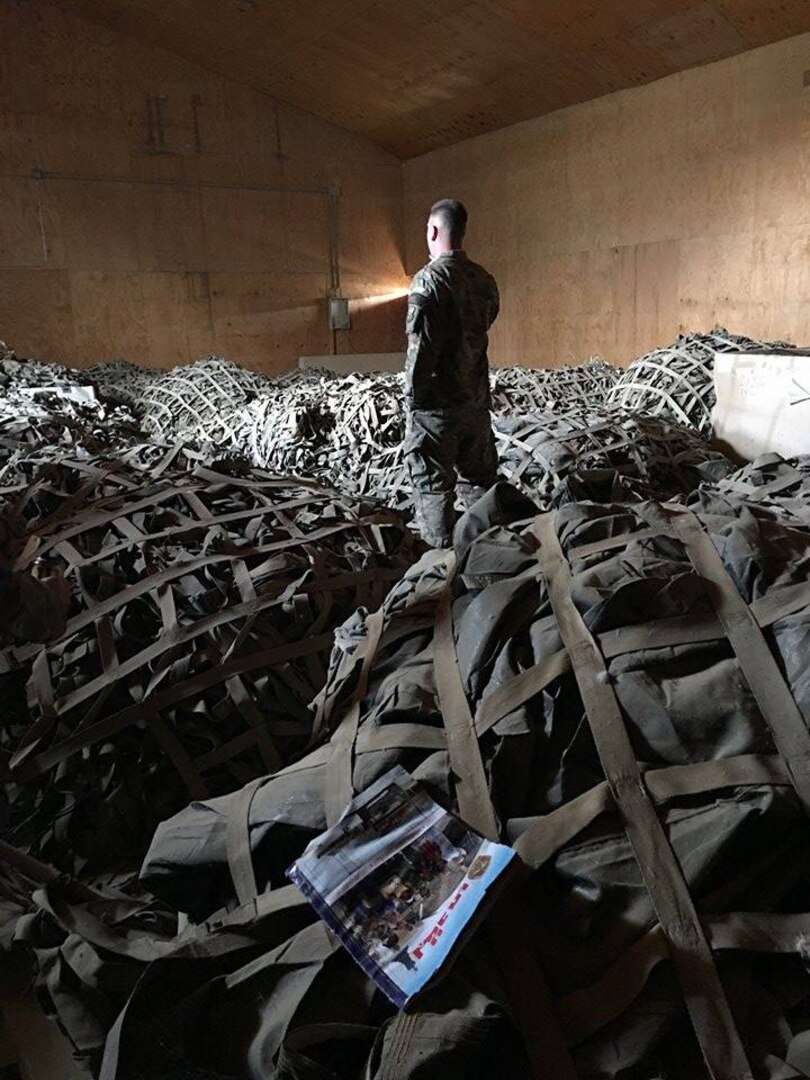 Tech. Sgt. Seth Lobdell, an air advisor for air transportation assigned to the 770th Air Expeditionary Advisory Squadron, stands in a room full of recovered cargo nets in Baghdad, Iraq, April 16, 2017. The pallet recovery initiative, led by aerial porters at the Baghdad Diplomatic Support Center, Iraq, involved the recovery of more than 1,500 aircraft pallets and 1,600 cargo nets, which were used for foreign military sales cargo destined for the Iraqi military to fight ISIS in Mosul. (U.S. Air Force courtesy photo)