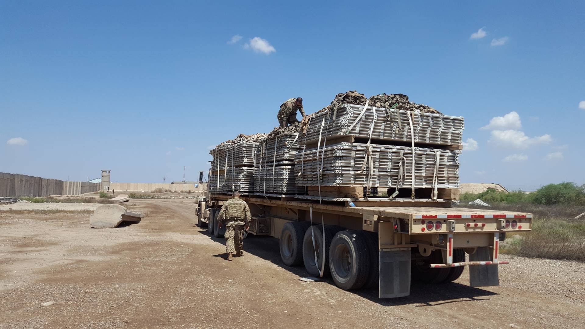 Members of the U.S. Army 574th Combat Support Command secure a load of recovered 463L pallets onto an U.S. Army truck at Al Muthana Air Base, Iraq, April 16, 2017. The pallet recovery initiative, led by aerial porters at the Baghdad Diplomatic Support Center, Iraq, involved the recovery of more than 1,500 aircraft pallets and 1,600 cargo nets, which were used for foreign military sales cargo destined for the Iraqi military to fight ISIS in Mosul. (U.S. Air Force courtesy photo)