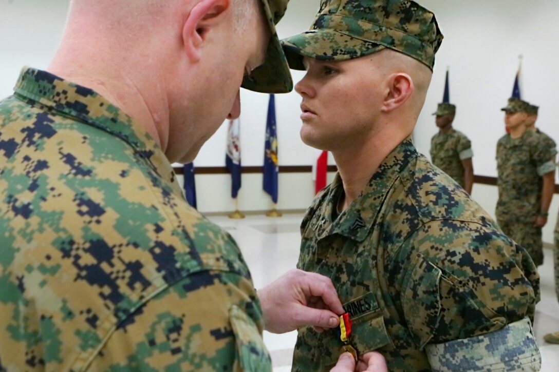 Lt. Col. Vincent Dawson, left, executive officer of Marine Aircraft Group 41, Marine Forces Reserve, awards Cpl. David Qualls the Navy and Marine Corps medal at the 1st Battalion, 23rd Marine Regiment headquarters in Houston, Texas, May 20, 2017. In 2014, Qualls helped save a man stuck in a burning vehicle. Marine Corps photo by Cpl. Dallas Johnson