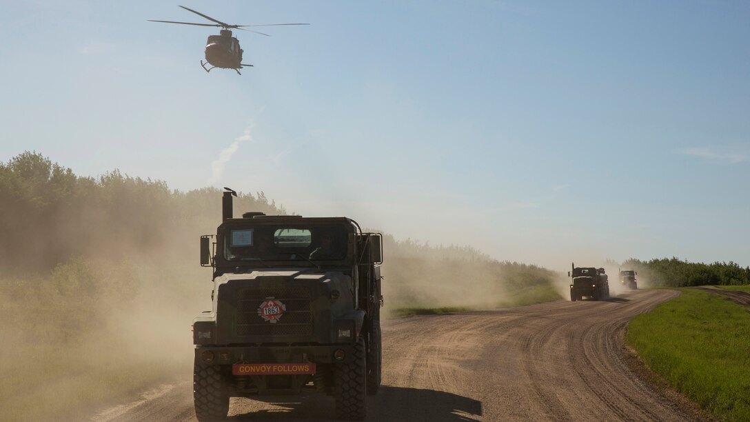 Marines assigned to Marine Wing Support Squadron 473, 4th Marine Aircraft Wing, Marine Forces Reserve, convoy to the Canadian Manoeuvre Training Centre, Camp Wainwright accompanied by two Royal Canadian Air Force Bell CH-146 Griffons in Alberta, Canada, May 30, 2017, during exercise Maple Flag 50. MWSS-473 convoyed to the training center to provide real world refueling support to Royal Canadian Air Force CH-147 Chinook and CH-146 Griffon type model series during exercise Maple Flag 50.