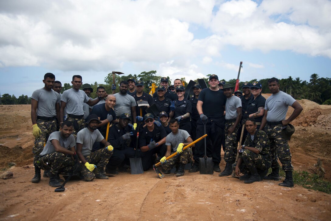 Amercian sailors assigned to the Ticonderoga-class guided missile cruiser USS Lake Erie pose for a group photo with the Sri Lankan Marine Corps in Matara, Sri Lanka, June 13, 2017. The USS Lake Erie arrived in Sri Lanka to support humanitarian assistance operations in the wake of severe flooding and landslides that devastated many regions of the country. Recent heavy rainfall brought by a southwest monsoon triggered flooding and landslides throughout the country, displacing thousands of people and causing significant damage to homes and buildings. Navy photo by Petty Officer 3rd Class Lucas T. Hans