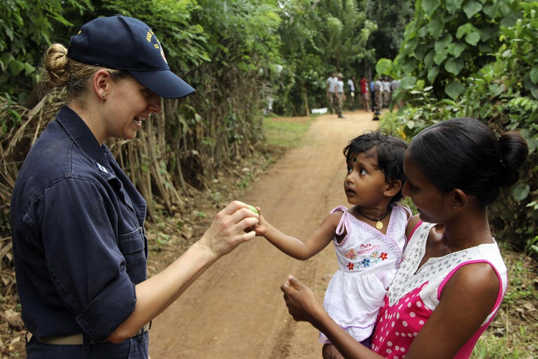 An American sailor assigned to the Ticonderoga-class guided-missile cruiser USS Lake Erie makes friends in Sri Lanka during humanitarian assistance operations in the wake of severe flooding and landslides that devastated many regions of the country in Matara, Sri Lanka, June 13, 2017. Recent heavy rainfall brought by a southwestern monsoon triggered flooding and landslides throughout the country, displacing thousands of people and causing significant damage to homes and buildings. Navy photo by Ensign Nicholas Ransom