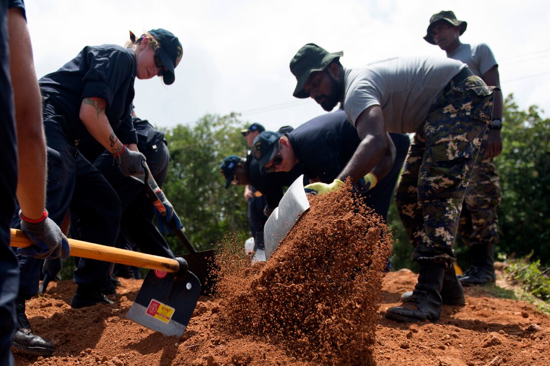 American sailors assigned to the Ticonderoga-class guided missile cruiser USS Lake Erie rebuild a levee with the Sri Lankan Marine Corps to support humanitarian assistance operations in the wake of severe flooding and landslides that devastated many regions of the country in Martra, Sir Lanka, June 13, 2017. Recent heavy rainfall brought by a southwest monsoon triggered flooding and landslides throughout the country, displacing thousands of people and causing significant damage to homes and buildings. Navy photo by Petty Officer 3rd Class Lucas T. Hans