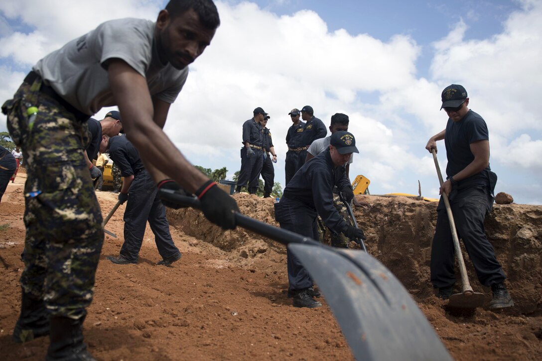 American sailors assigned to the Ticonderoga-class guided missile cruiser USS Lake Erie rebuild a levee with the Sri Lankan Marine Corps to support humanitarian assistance operations in the wake of severe flooding and landslides that devastated many regions of the country in Matara, Sri Lanka, June 13, 2017. Recent heavy rainfall brought by a southwest monsoon triggered flooding and landslides throughout the country, displacing thousands of people and causing significant damage to homes and buildings. Navy photo by Petty Officer 3rd Class Lucas T. Hans