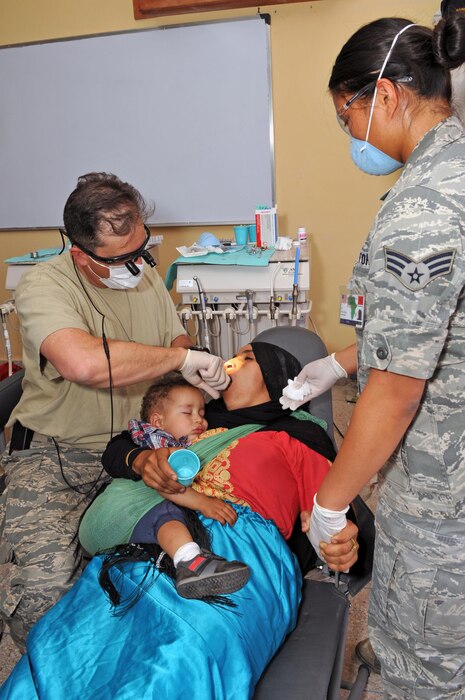 Lt. Col. Joshua Wyte, a dentist with the 140th Medical Group, and Senior Airman Skyla Spotkaeff, a dental technician with the 140th MDG provide dental care in Akka Ighane, Morocco on April 21, 2017. (U.S. Air National Guard photo by Tech. Sgt. Annie Edwards)