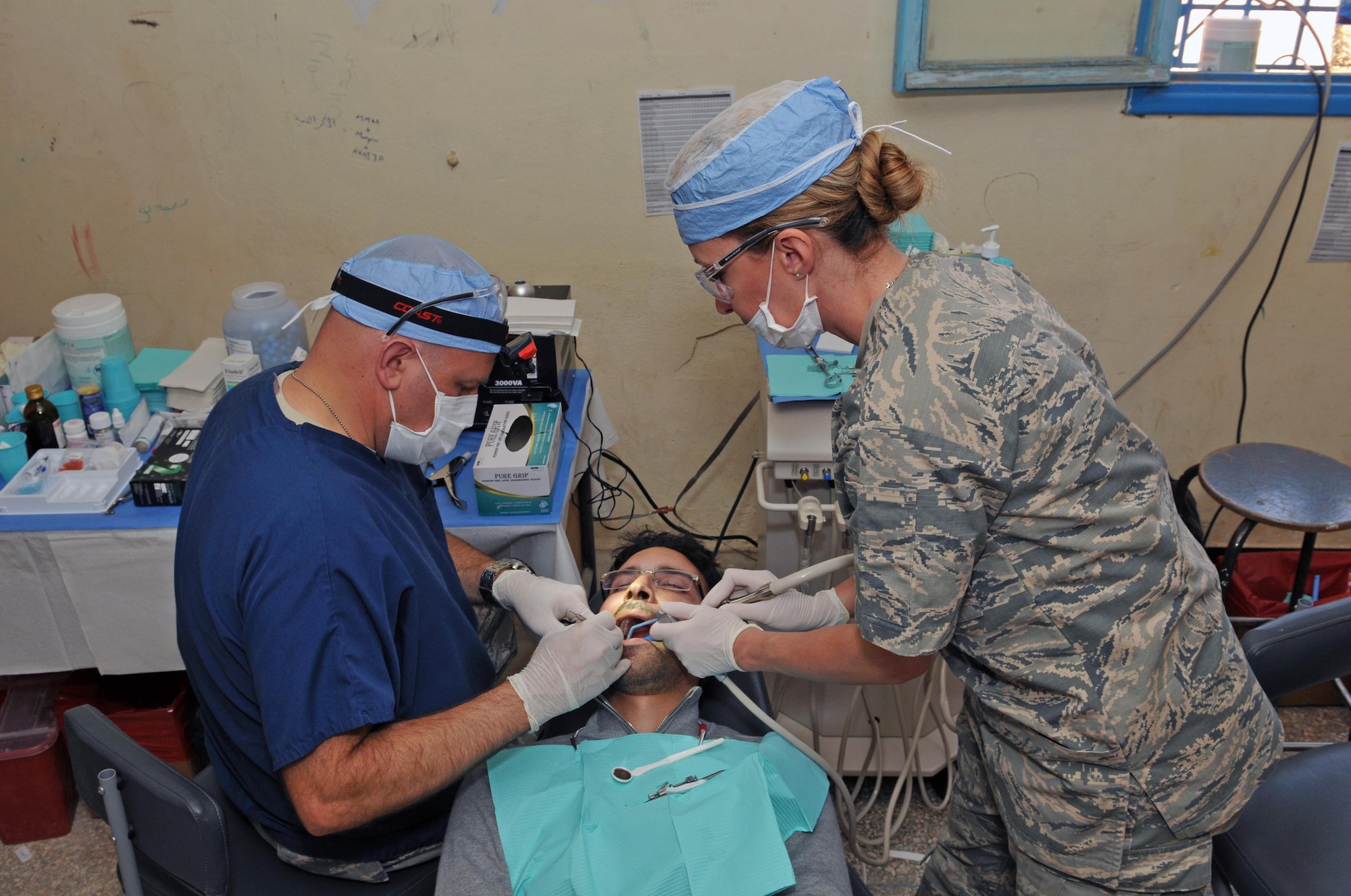 Lt. Col. Paul Anderson, a dentist with the 151st Medical Group, and Senior Airman Kristin Bentley, a dental technician with the 151st MDG, provide dental care in conjunction with their Moroccan counterparts at Issafen, Morocco on April 25, 2017 during African Lion. (U.S. Air National Guard photo by Tech. Sgt. Annie Edwards)