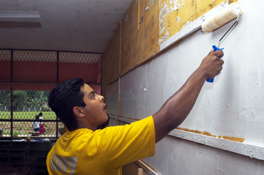 Navy Seaman York Pimiento, who's assigned to the Ticonderoga-class guided missile cruiser USS Lake Erie, paints a classroom of the Mallika Nawodya School to support humanitarian assistance operations in Sri Lanka in the wake of severe flooding and landslides that devastated many regions of the country in Galle, Sri Lanka, June 14, 2017. Recent heavy rainfall brought by a southwest monsoon triggered flooding and landslides throughout the country, displacing thousands of people and causing significant damage to homes and buildings. Navy photo by Petty Officer 3rd Class Lucas T. Hans