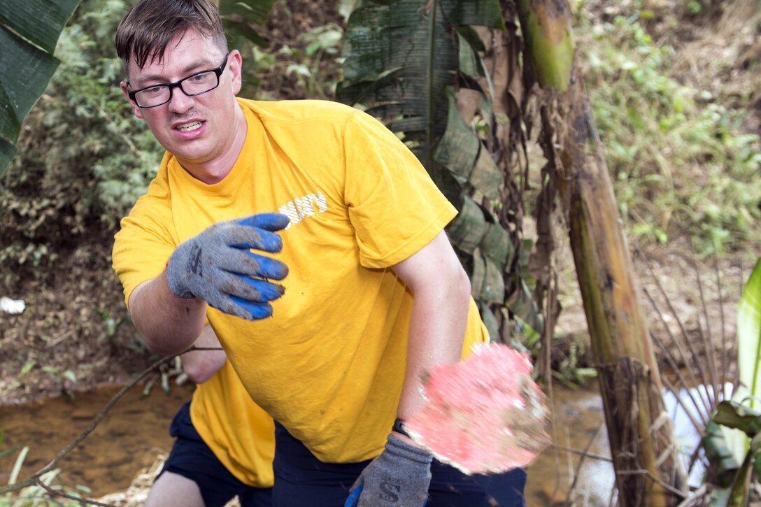 Navy Petty Officer 2nd Class Timothy Butchko, who's assigned to the Ticonderoga-class guided-missile cruiser USS Lake Erie, moves debris from the Mallika Nawodya School in Sri Lanka during a community engagement event in support of humanitarian assistance operations in the wake of severe flooding and landslides that devastated many regions of the country near Galle, Sri Lanka, June 14, 2017. Recent heavy rainfall brought by a southwestern monsoon triggered flooding and landslides throughout the country, displacing thousands of people and causing significant damage to homes and buildings. Navy photo by Petty Officer 2nd Class Joshua Fulton