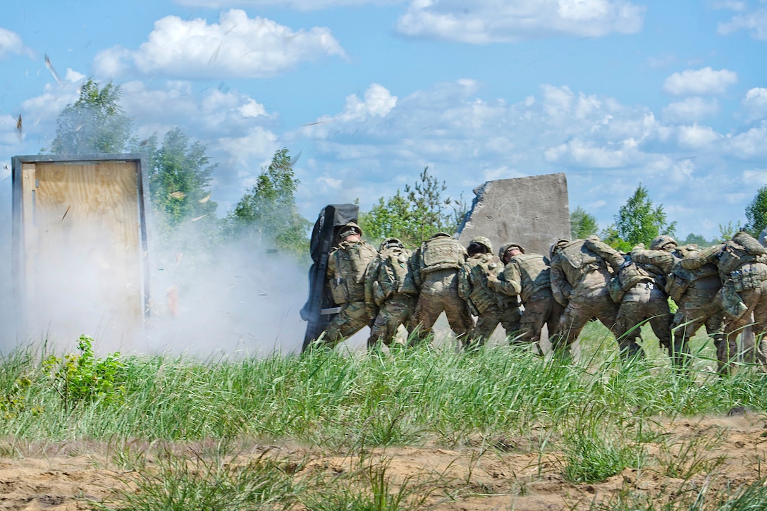 Soldiers protect themselves using a blast shield while conducting demolition training at Bemowo Piskie, Poland, June 8, 2017. The training is part of Saber Strike 17, a U.S. Army Europe-led multinational combined forces exercise designed to enhance the NATO alliance throughout the Baltic region and Poland. The soldiers are assigned to Alpha Troop, Regimental Engineer Squadron, 2nd Cavalry Regiment. Army photo by Sgt. Justin Geiger