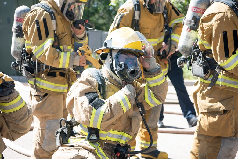 CHEYENNE MOUNTAIN AIR FORCE STATION, Colo. – A recruit from the Colorado Springs Fire Department training division seals the mask on his personal protective gear before entering the flashover trainer at Cheyenne Mountain Air Force Station, Colo., fire training area, June, 9, 2017. The Colorado Springs Fire Department and the Cheyenne Mountain AFS often conduct joint training and operations as part of their mutual support agreement that covers the Cheyenne Mountain region of the Front Range. (U.S. Air Force photo by Steve Kotecki)