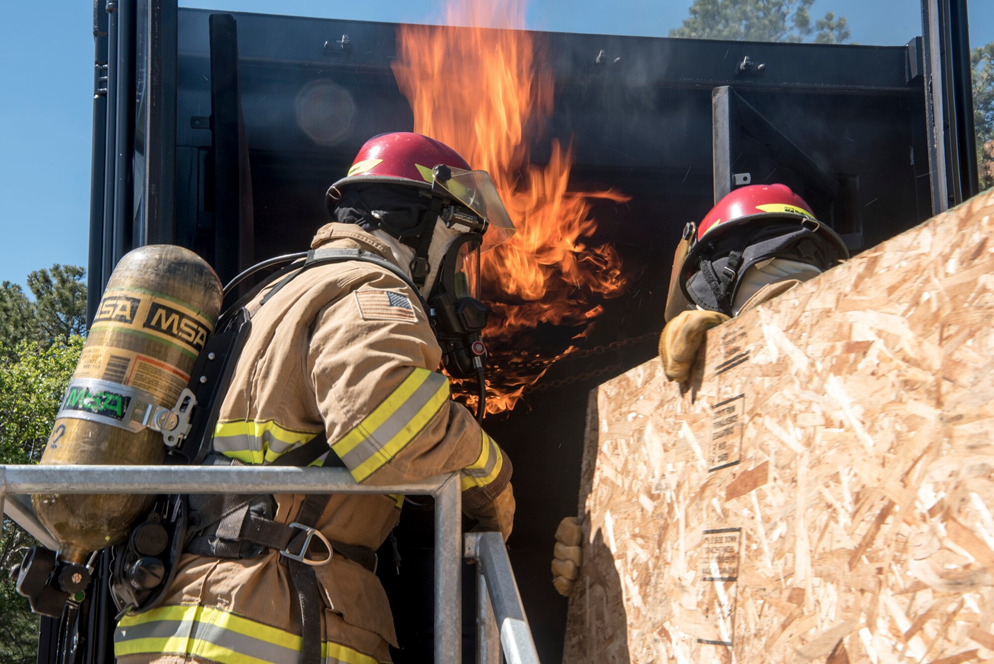 CHEYENNE MOUNTAIN AIR FORCE STATION, Colo. – Firefighters from the Colorado Springs Fire Department and the Chyenne Mountain Air Force Station Fire Department conducted a joint training mission at the Cheyenne Mountain AFS, Colo., fire training area, June, 9, 2017. The training consisted of the flashover trainer seen here and use of the three-story fire training building. (U.S. Air Force photo by Steve Kotecki)