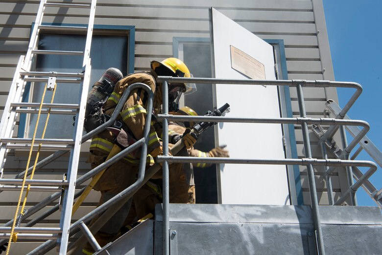 CHEYENNE MOUNTAIN AIR FORCE STATION, Colo. –  Recruits from the Colorado Springs Fire Department training division prepare to enter the three-story fire training building at the Cheyenne Mountain Air Force Station, Colo., fire training area, June, 9, 2017. For the recruits this was their first training operation that involved a live fire simulation. (U.S. Air Force photo by Steve Kotecki)