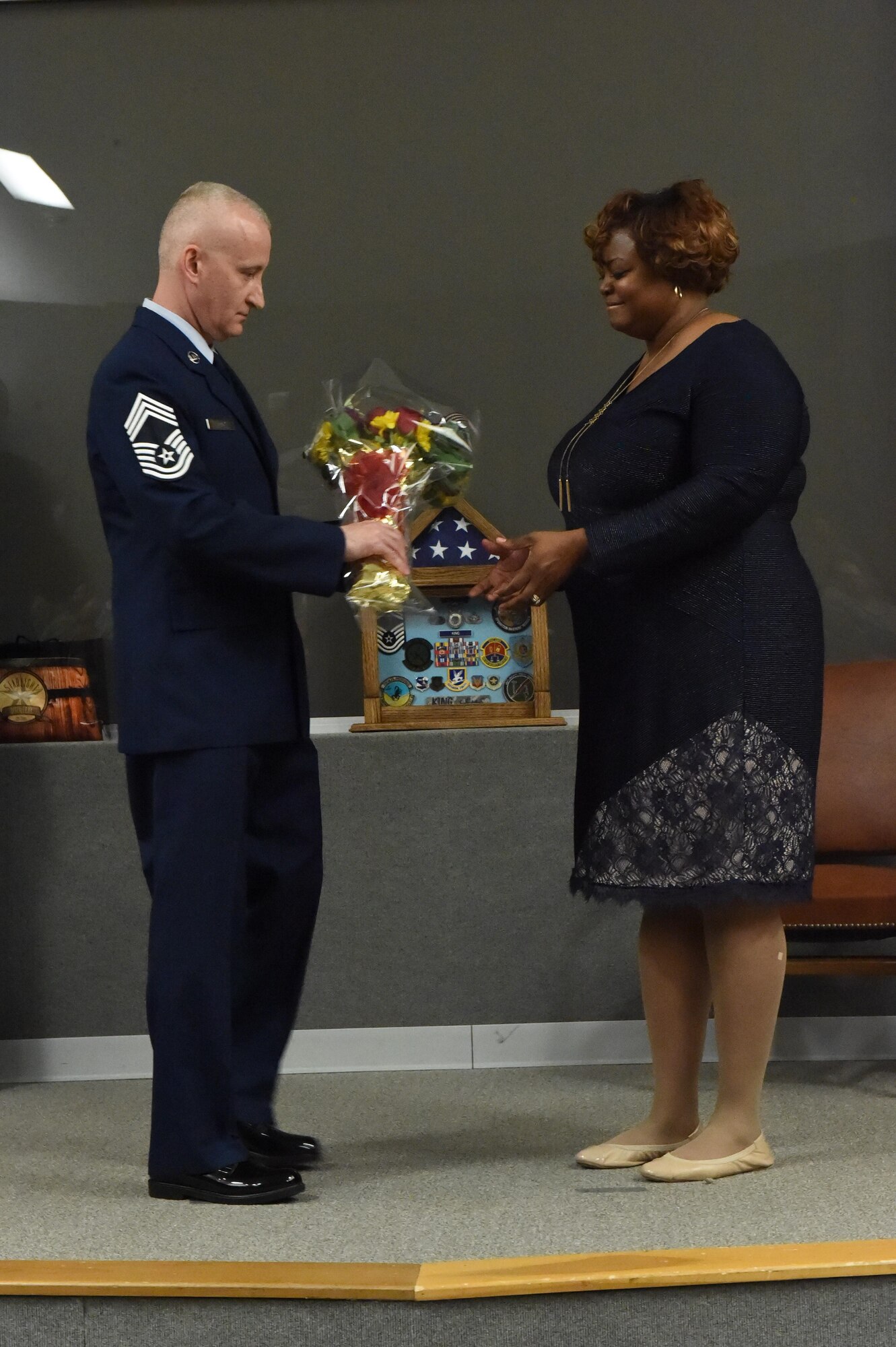 Chief Master Sgt. Rickie King, 434th Security Forces Squadron manager, presents a bouquet of flowers to his wife, Nancy King at a retirement ceremony at Grissom Air Reserve Base, Ind., June 3, 2017. He recognized her for undeniable support throughout his service. (U.S. Air Force photo/ Senior Airman Cali Wetli)