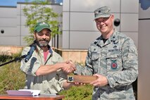Andy Schlosberg, a Colorado State Forester, presents a Tree City USA plaque to Lt. Col. Andrew DeRosa, 50th Civil Engineer Squadron commander, at the Child Development Center at Schriever Air Force Base, Colorado, Friday, June 9, 2017.  The presentation was made on Arbor Day in honor of Schriever's 19th year as a Tree City USA recipient. (U.S. Air Force Photo/Dennis Rogers)