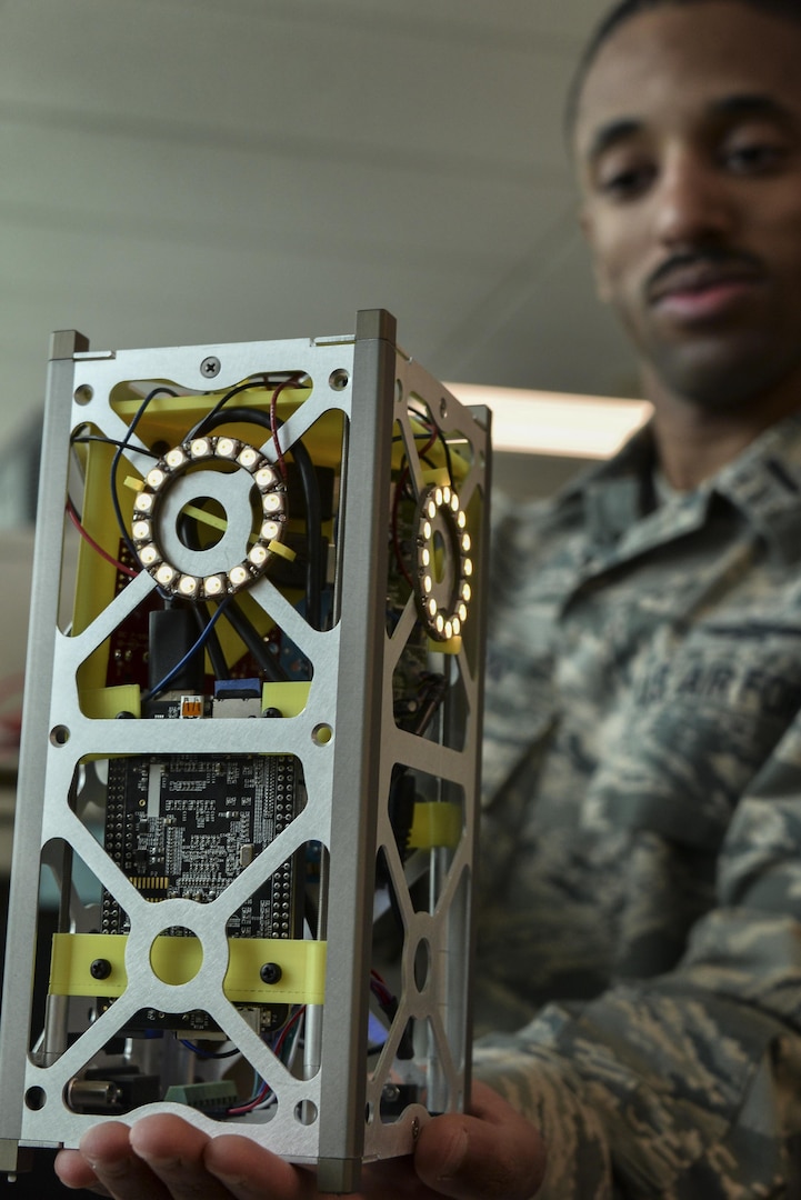 To represent the space segment during the Space Cyber Challenge, teams developed miniature satellites, or CubeSats, with sensor boards. The realistic CubeSats simulated thrusters with light-emitting diodes, LED ring lights.  (U.S. Air Force photo/Staff Sgt. Alexandre Montes) 