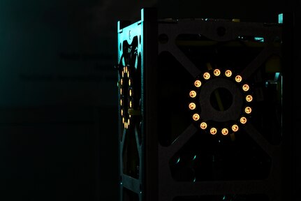 The glowing LED lights on a miniature satellite, or CubeSat, simulate its thrusters firing during a demonstration May 22, 2017, in Linthicum Heights, Maryland. Five 707th CS Airmen, alongside NSA personnel and NASA engineers, competed with graduate students from the Royal Military College of Canada in a Space Cyber Challenge. (U.S. Air Force photo/Staff Sgt. Alexandre Montes) 