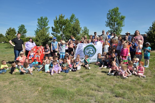 Child Development Center youth and staff celebrate Arbor Day with a tree planting courtesy of the 50th Civil Engineering Squadron and the Colorado State Forestry Service at the CDC at Schriever Air Force Base, Colorado, Friday, June 9, 2017. The planting marked the 19th consecutive year of Schriever’s recognition as a Tree City USA recipient. (U.S. Air Force Photo/Dennis Rogers)