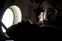 U.S. Air Force Reserve Senior Airman Anthony Miller, loadmaster, 327th Airlift Squadron, scans the horizon from the porthole of a C-130J Super Hercules during a flight to Keesler Air Force Base, Miss., June 2, 2017. Miller assisted in the transportation of passengers and cargo during exercise Prime Horizon, the 913th Airlift Group’s first readiness exercise. (U.S. Air Force photo by Master Sgt. Jeff Walston/Released)