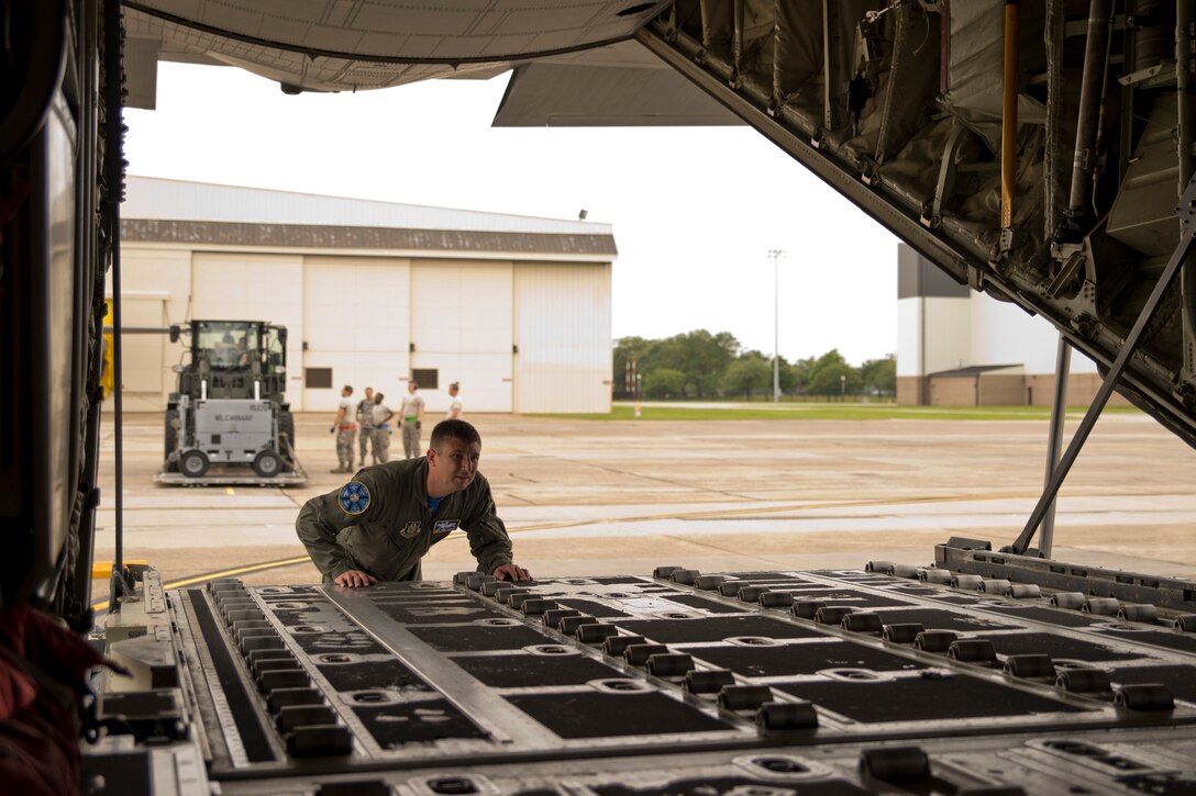 U.S. Air Force Reserve Tech Sgt. Nate Castle, loadmaster, 327th Airlift Squadron, checks the bay of a C-130J Super Hercules before the on load of cargo during Exercise Prime Horizon June 3, 2017, at Keesler Air Force Base, Miss. Castle loaded and unloaded cargo and passengers in Arkansas and Mississippi as part of exercise Prime Horizon. The exercise provided vital training to the 327 AS loadmasters due to the overall height of the vehicle and the lack of easily accessible tiedown points. (U.S. Air Force photo by Master Sgt. Jeff Walston/Released)