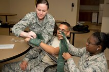 U.S. Air Force Reserve Staff Sgt. Rachel Clark, personnel journeyman, and Senior Airman Alexandria, career development, splint the arm of Tech Sgt. Robert Porras, customer service NCOIC, during exercise Prime Horizon June 3, 2017, at Keesler Air Force Base, Miss.  All three Airmen are assigned 913th Force Support Squadron and were participating in the 913th Airlift Group’s first readiness exercise. (U.S. Air Force photo by Master Sgt. Jeff Walston/Released)