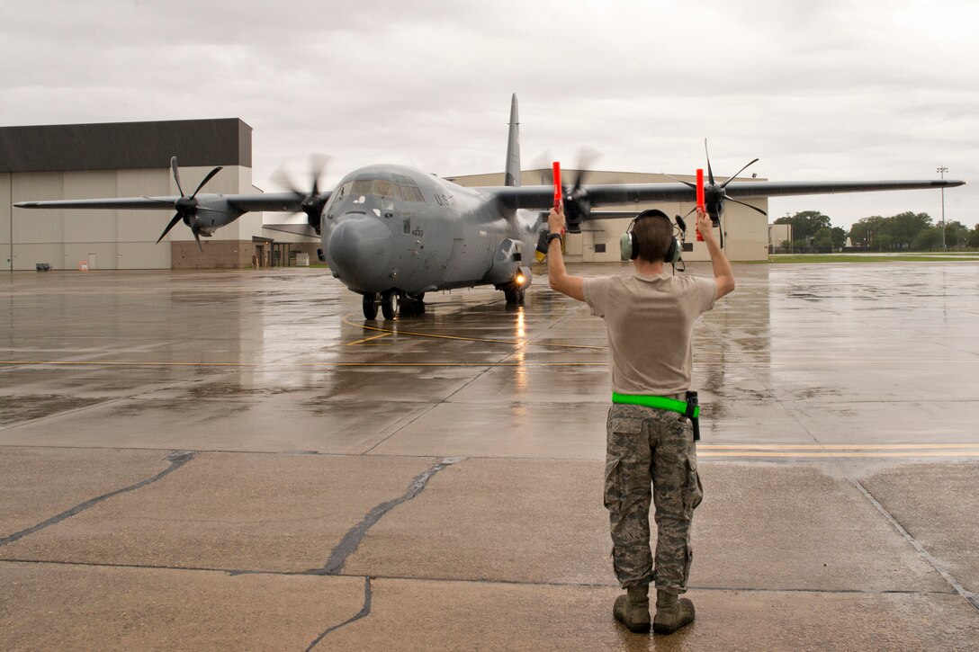 U.S. Air Force Reserve Tech Sgt. Jimme McDougall, crew chief, 913th Aircraft Maintenance Squadron, marshals a C-130J Super Hercules to a parking spot at Keesler Air Force Base, Miss., June 3, 2017. McDougall was one of several maintainers from the 913 MXS who provided maintenance support to aircraft at Keesler during the 913th Airlift Group’s first readiness exercise. (U.S. Air Force photo by Master Sgt. Jeff Walston/Released)