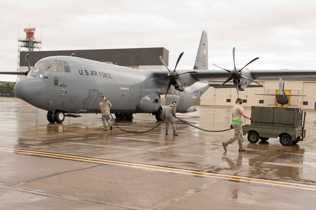 U.S. Air Force Reserve Airmen assigned to the 913th Maintenance Squadron prepare to connect a power cord to a receptacle on a C-130J Super Hercules at Keesler Air Force Base, Miss., June 3, 2017. Power is supplied to the aircraft by generators so maintainers can run checks on the electrical environmental systems. (U.S. Air Force photo by Master Sgt. Jeff Walston/Released)