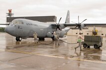 U.S. Air Force Reserve Airmen assigned to the 913th Maintenance Squadron prepare to connect a power cord to a receptacle on a C-130J Super Hercules at Keesler Air Force Base, Miss., June 3, 2017. Power is supplied to the aircraft by generators so maintainers can run checks on the electrical environmental systems. (U.S. Air Force photo by Master Sgt. Jeff Walston/Released)