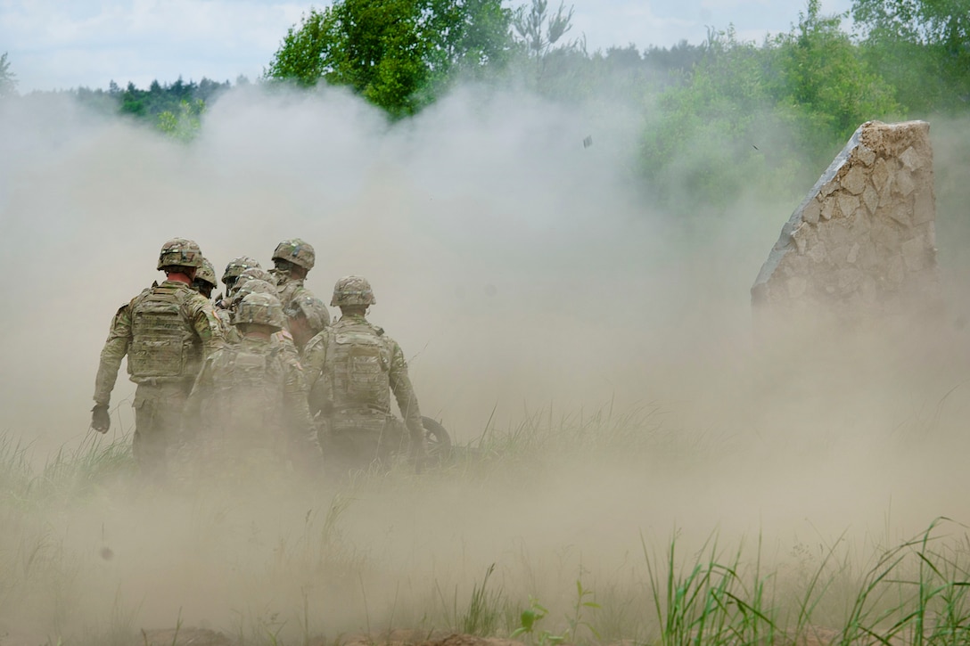 Soldiers walk through debris after conducting demolition training in Bemowo Piskie, Poland, June 8, 2017. The training is part of Saber Strike 17, a U.S. Army Europe-led multinational combined forces exercise designed to enhance the NATO alliance throughout the Baltic region and Poland. Army photo by Sgt. Justin Geiger