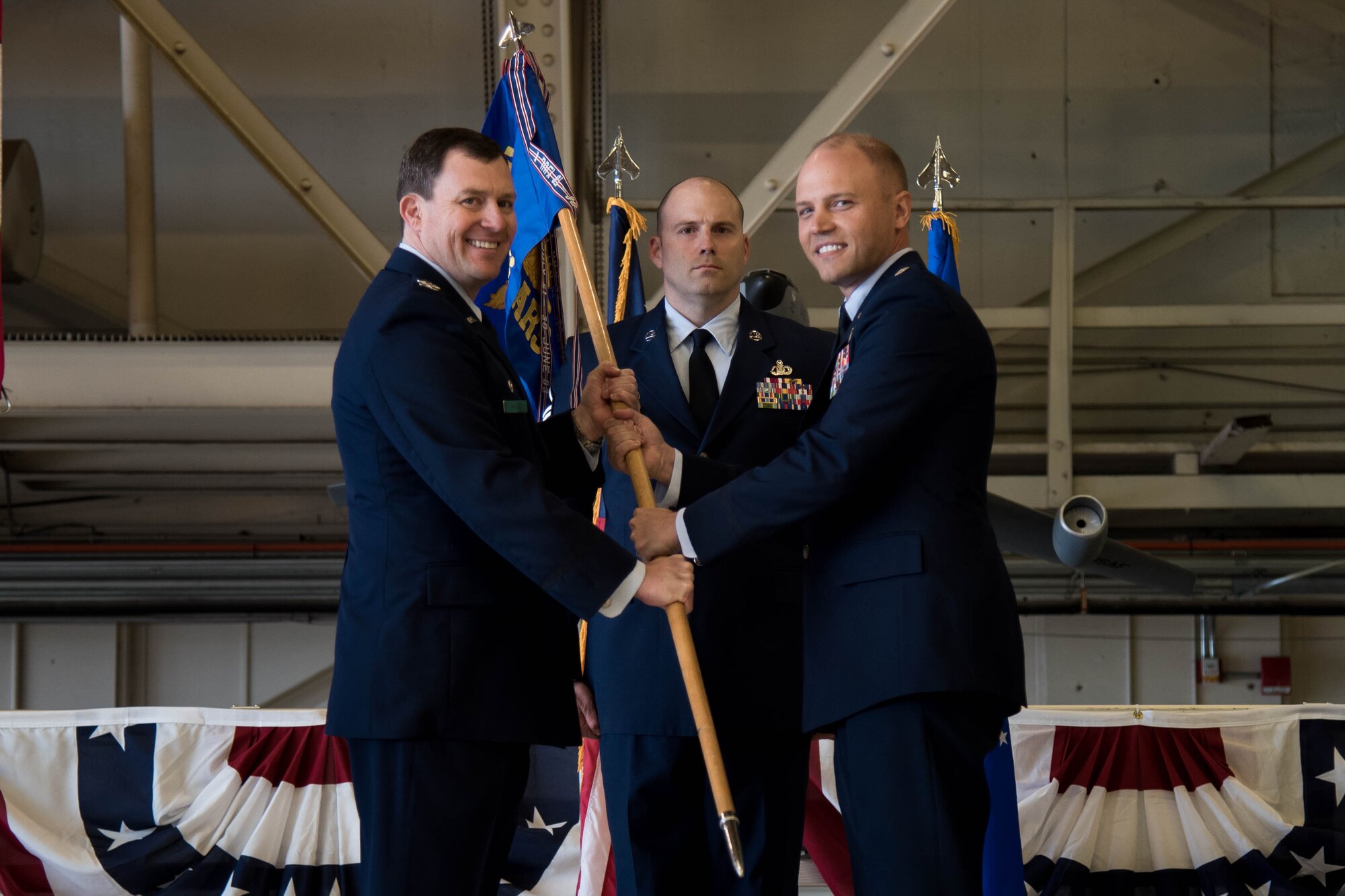 Col. Todd Cargle, 92nd Operations Group commander, passes the 92nd Air Refueling Squadron guidon to Lt. Col. Matthew Collins, 92nd ARS commander, during a change of command ceremony June 2, 2017 at Fairchild Air Force Base, Washington. Collins assumed command from Lt. Col. Jason Brown. (U.S. Air Force photo/Senior Airman Sean Campbell)