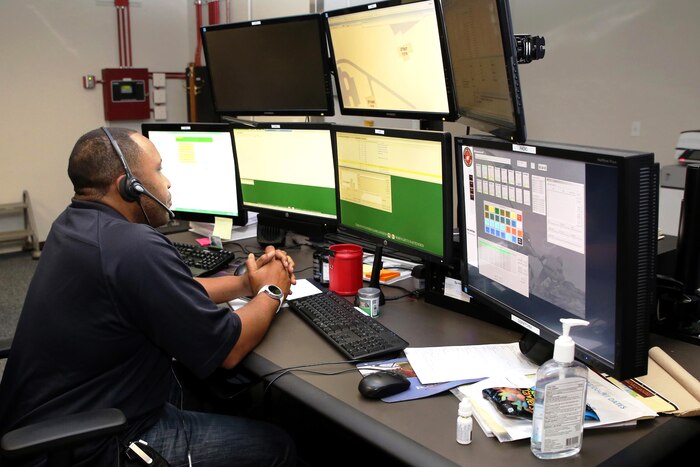 An emergency dispatcher uses the newly-installed Consolidated Emergency Response System workstation at Marine Corps Base Quantico, Va.  CERS aggregates multiple capabilities into a single workstation. Marine Corps photo by Ashley Calingo