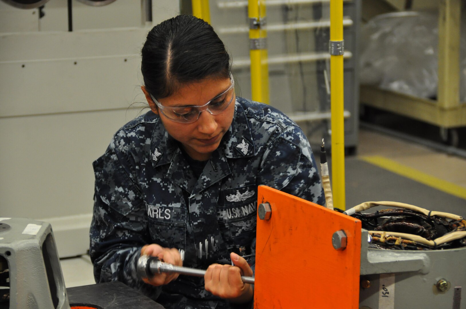 A Sailor with IMF Bangor’s Shop 51A (Inside Electrical Repair), is setting air gaps for pole pieces. (Photo by MMA1 (SS) Daniel Pitts, PSNS & IMF)