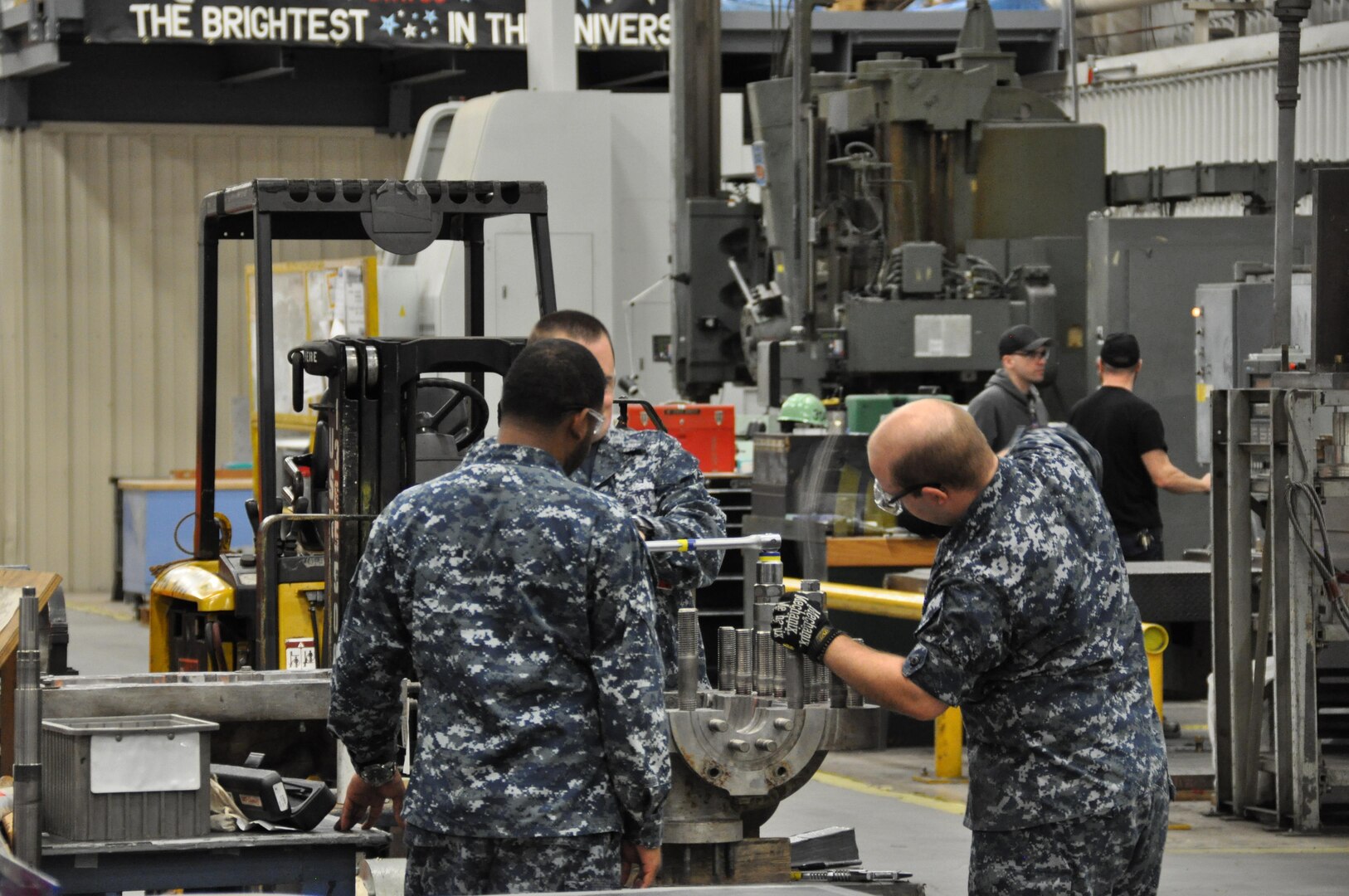 Sailors with the pump repair track of the NAMTS program are installing studs on a six-stage centrifugal trim and drain pump. (Photo by MMA1 (SS) Daniel Pitts, IMF & IMF)
