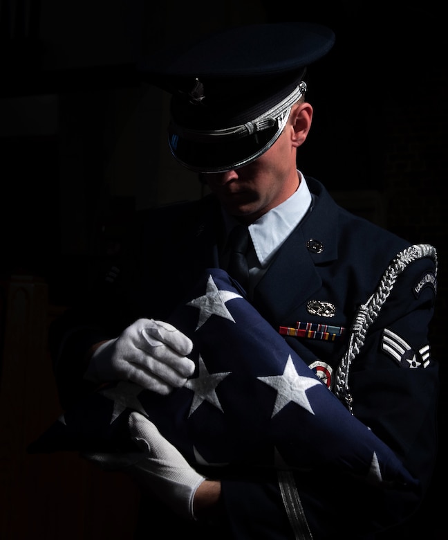 U.S. Air Force Senior Airman Luke Goins, 633d Force Support Squadron ceremonial honor guardsman, inspects the edges of the American Flag, after performing a flag folding ceremony at Joint Base Langley-Eustis, Va., June 12, 2017. It has been more than 100 years since the holiday’s inception by President Woodrow Wilson, in 1916. (U.S. Air Force photo/Staff Sgt. Carlin Leslie)